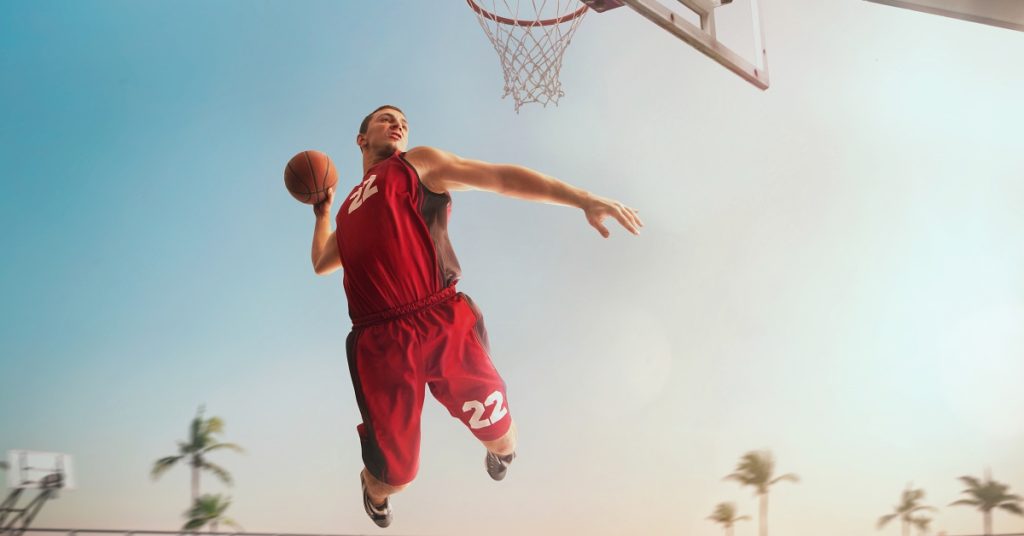 Basketball player in action on sunset.
