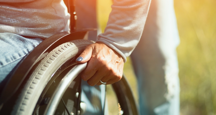 Detailed View Of A Hand On A Pushrim A Of Wheelchair. Disability Concept. Outdoor.