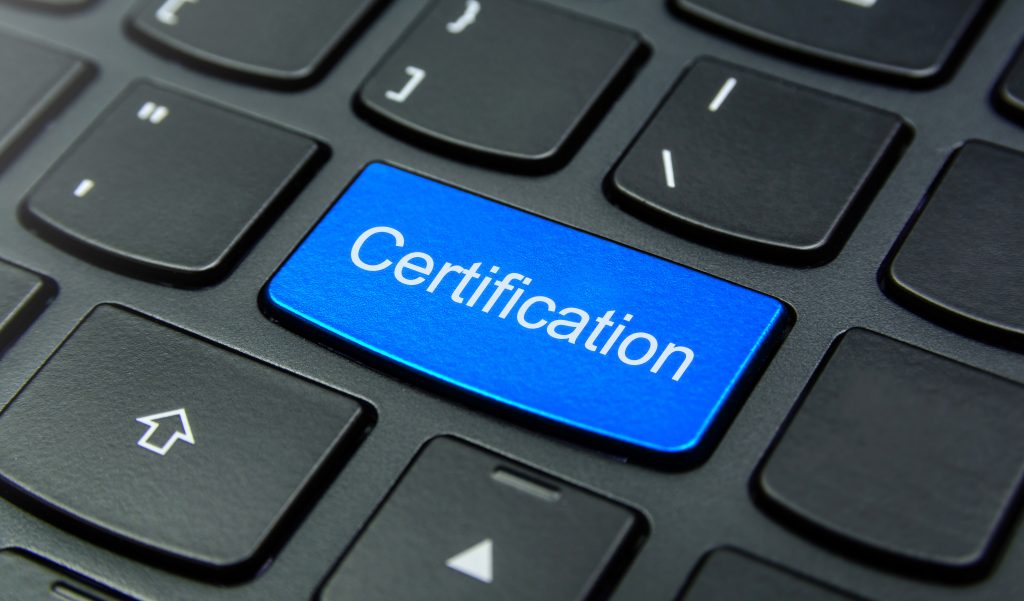 Business Concept: Close-up the Certification button on the keyboard and have Azure, Cyan, Blue, Sky color button isolate black keyboard